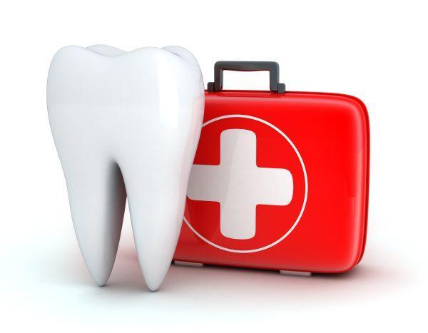 Dental tooth model next to a red medical kit
